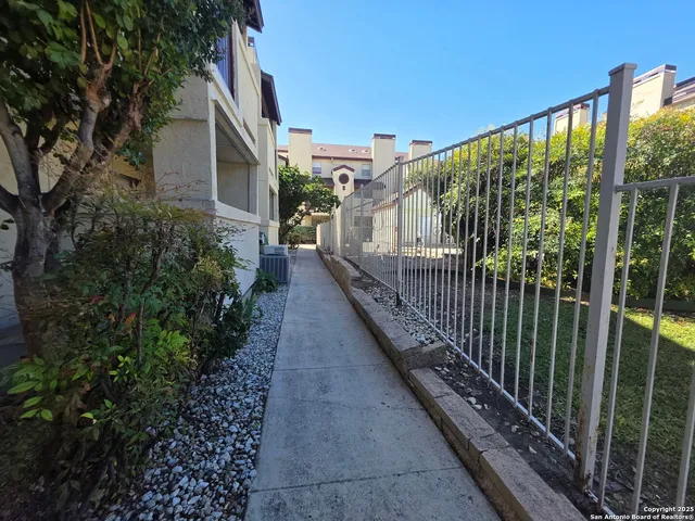 a view of a house with backyard and balcony