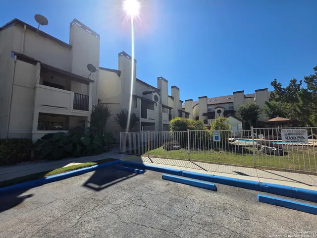 a view of swimming pool with a lounge chairs