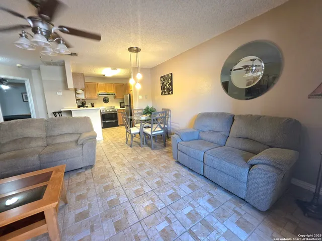a view of a livingroom and a dining hall with couches