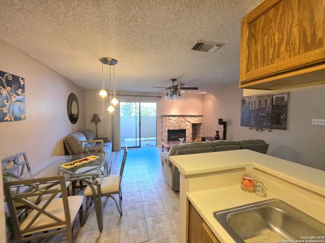 a kitchen with a sink a counter and chairs