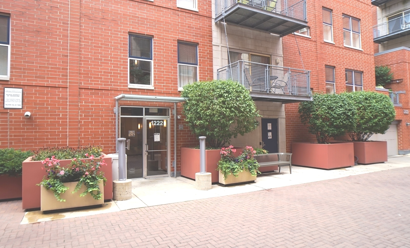 1222 Chicago Avenue, Unit 705 Evanston, IL 60202 - Photo 23 of 33 a front view of a building with potted plants