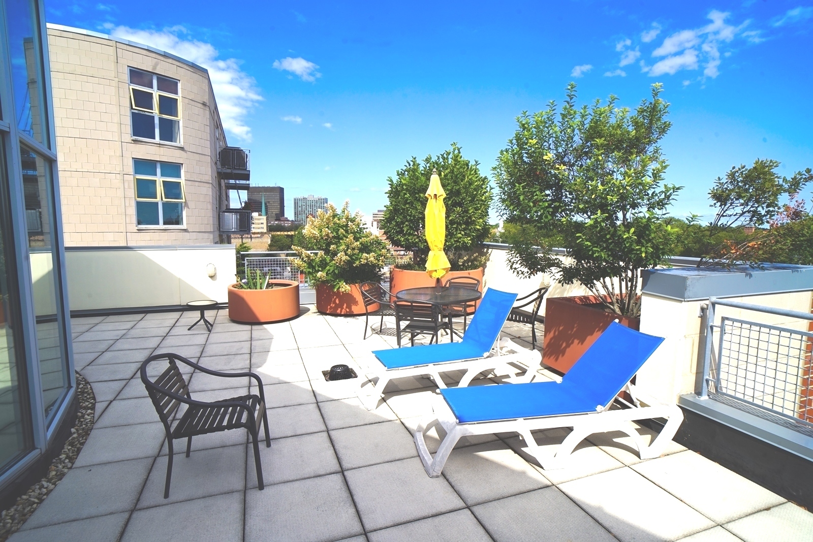 1222 Chicago Avenue, Unit 705 Evanston, IL 60202 - Photo 25 of 33 a view of a patio with couches table and chairs and potted plants