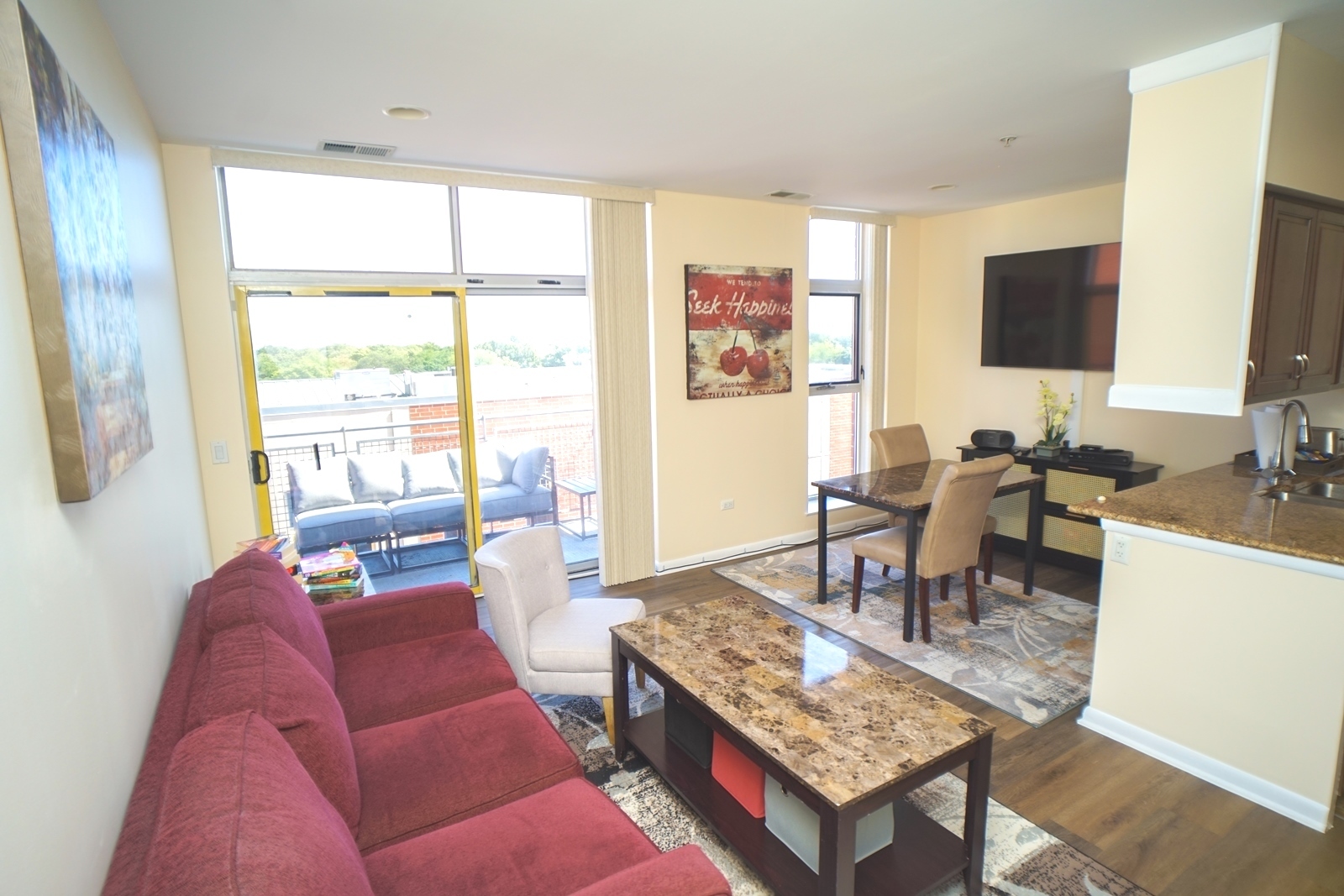 1222 Chicago Avenue, Unit 705 Evanston, IL 60202 - Photo 5 of 33 a living room with furniture and a flat screen tv
