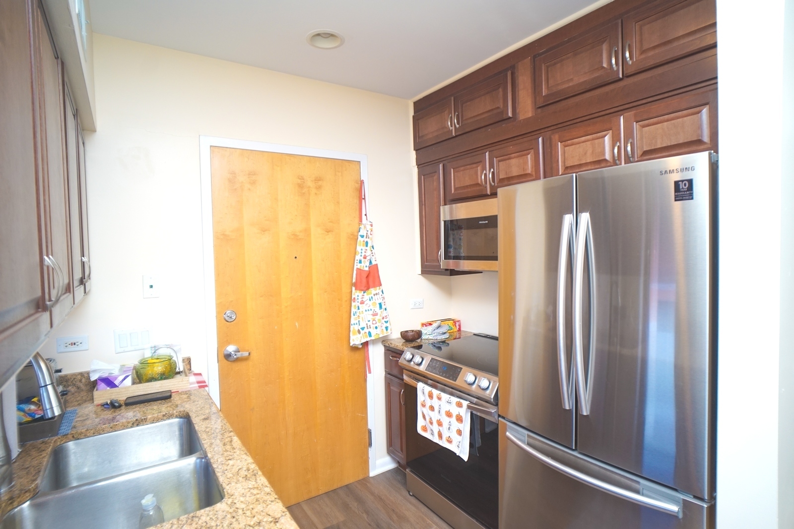 1222 Chicago Avenue, Unit 705 Evanston, IL 60202 - Photo 7 of 33 a kitchen with stainless steel appliances granite countertop a refrigerator and a window