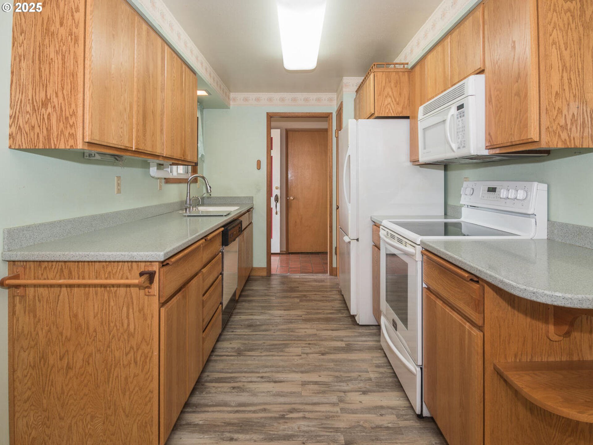 19838 Northeast Wasco Street Portland, OR 97230 - Photo 18 of 42 a kitchen with stainless steel appliances granite countertop a sink stove and cabinets