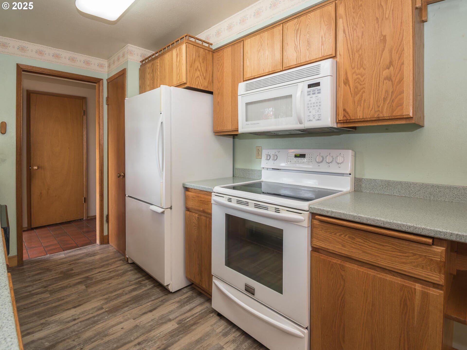 19838 Northeast Wasco Street Portland, OR 97230 - Photo 21 of 42 a white refrigerator freezer sitting inside of a kitchen