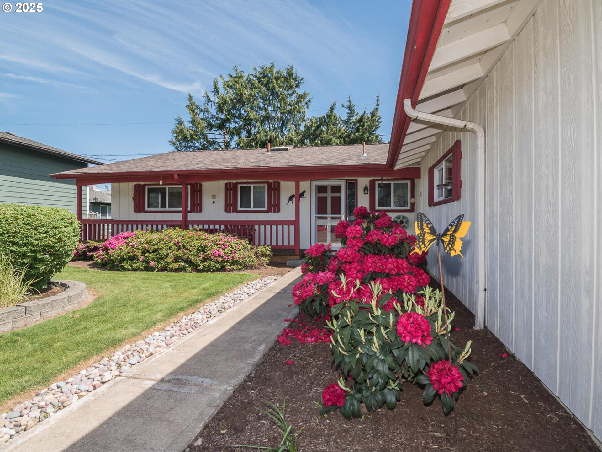 19838 Northeast Wasco Street Portland, OR 97230 - Photo 3 of 42 a front view of house and yard with beautiful flowers and flowers