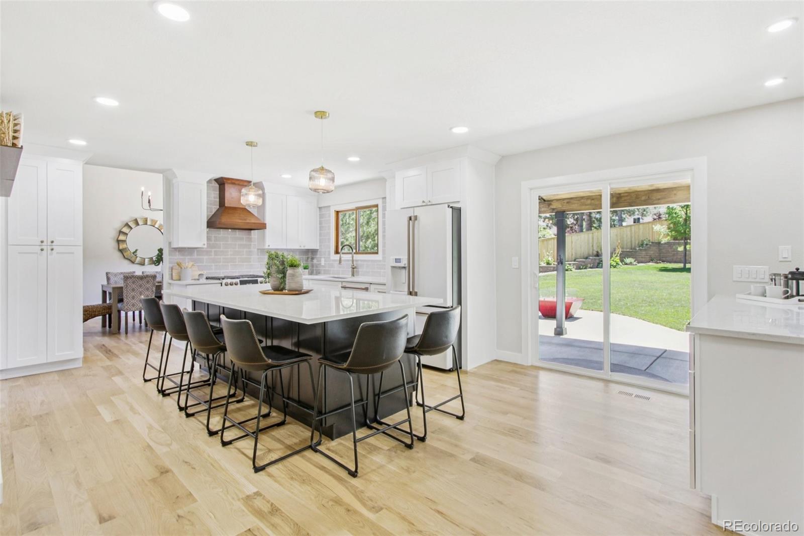 9810 Venneford Ranch Road Highlands Ranch, CO 80126 - Photo 13 of 50 a view of a dining room with furniture and wooden floor