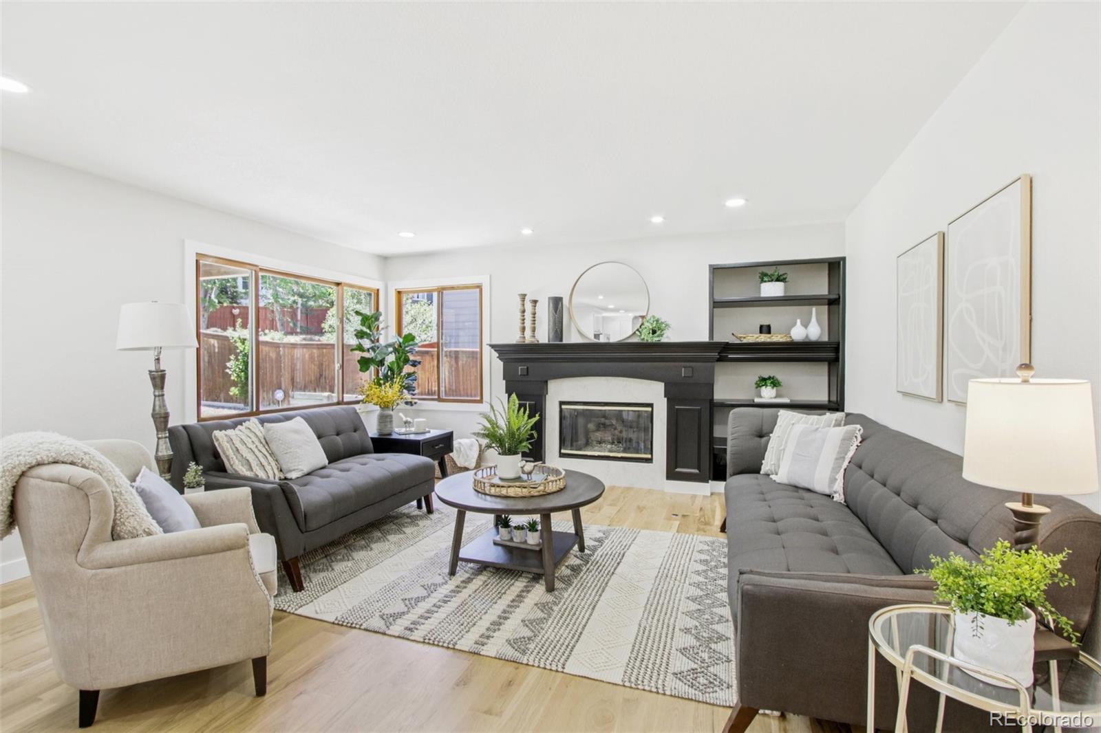 9810 Venneford Ranch Road Highlands Ranch, CO 80126 - Photo 14 of 50 a living room with furniture and a fireplace