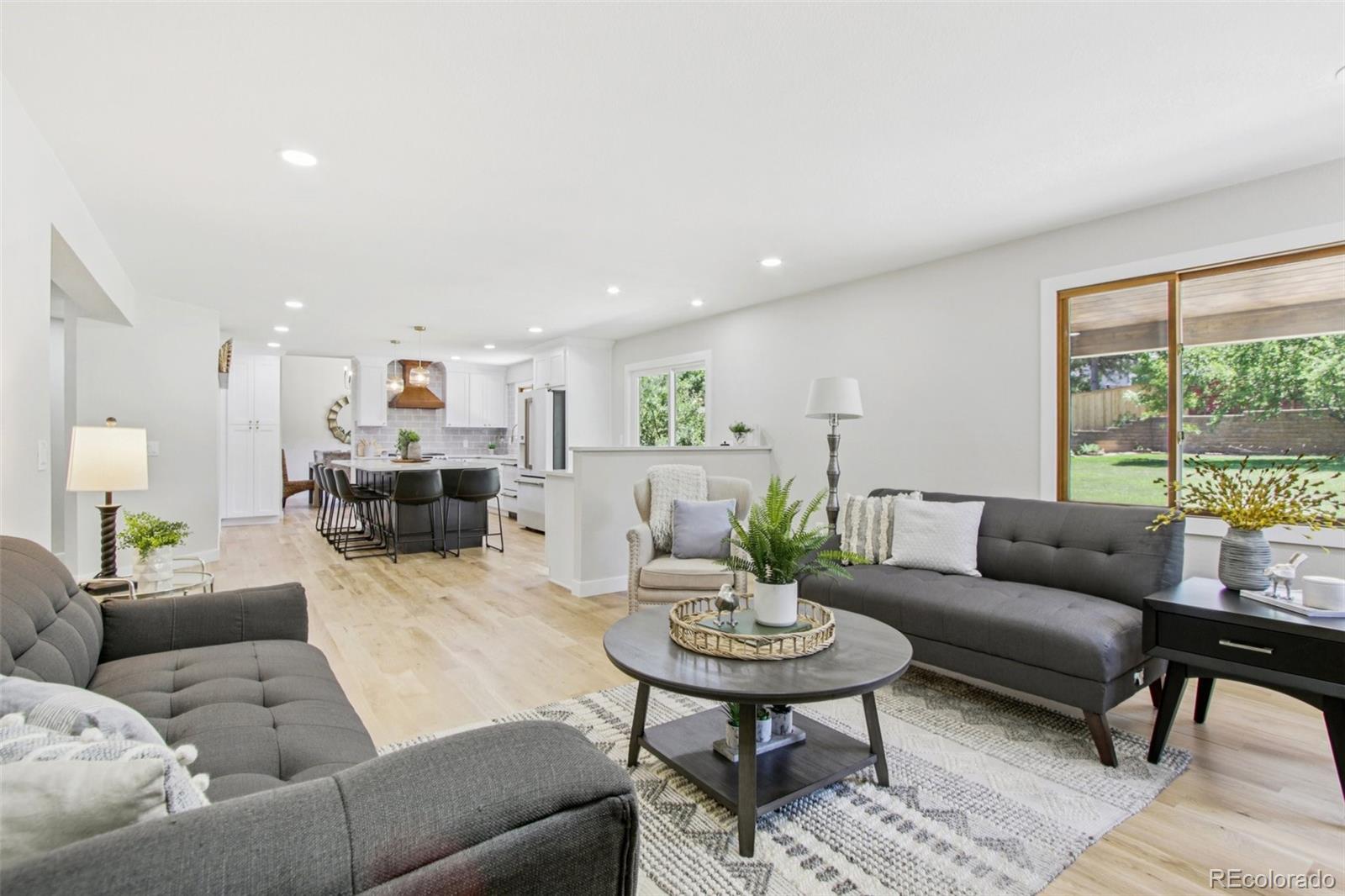 9810 Venneford Ranch Road Highlands Ranch, CO 80126 - Photo 15 of 50 a living room with furniture and a table