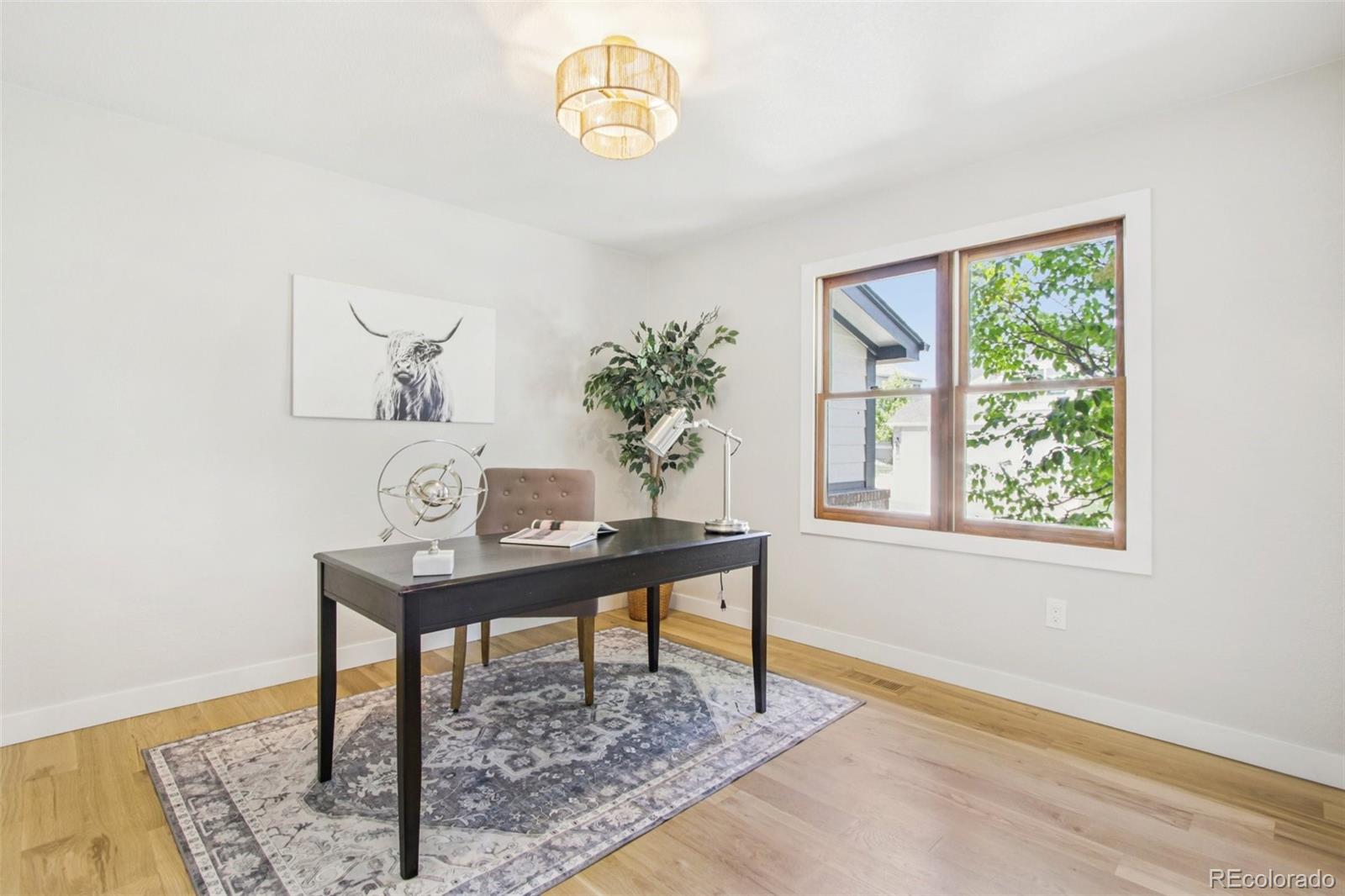 9810 Venneford Ranch Road Highlands Ranch, CO 80126 - Photo 19 of 50 a view of a room with a table and a potted plant
