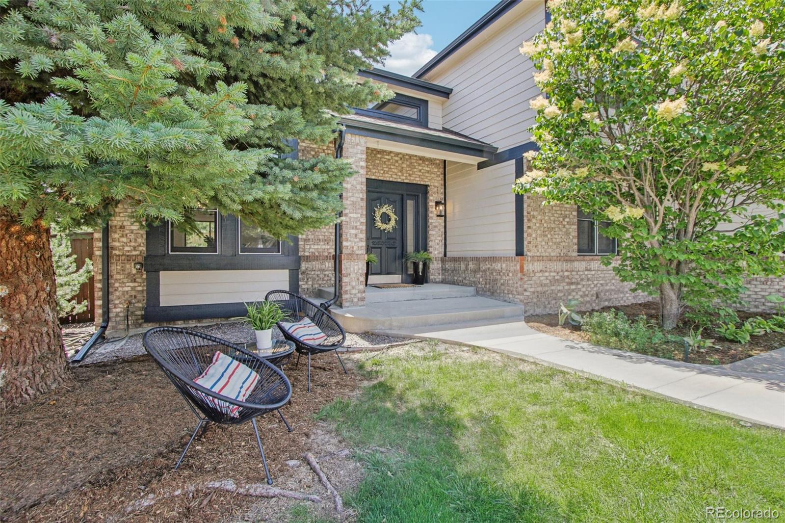 9810 Venneford Ranch Road Highlands Ranch, CO 80126 - Photo 2 of 50 a view of a backyard with furniture and a tree