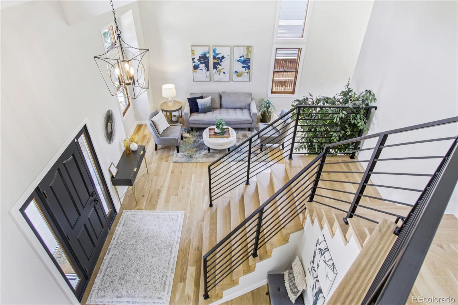 9810 Venneford Ranch Road Highlands Ranch, CO 80126 - Photo 21 of 50 a living room with furniture and a chandelier