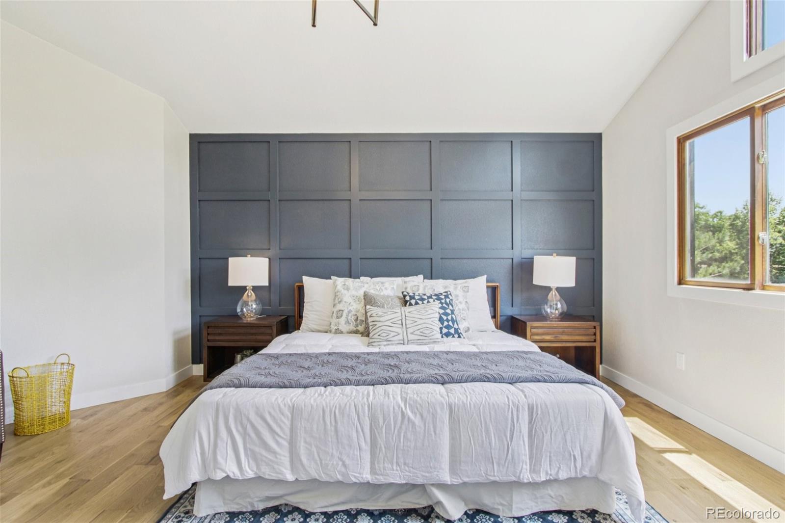 9810 Venneford Ranch Road Highlands Ranch, CO 80126 - Photo 23 of 50 a bedroom with a bed and wooden floor