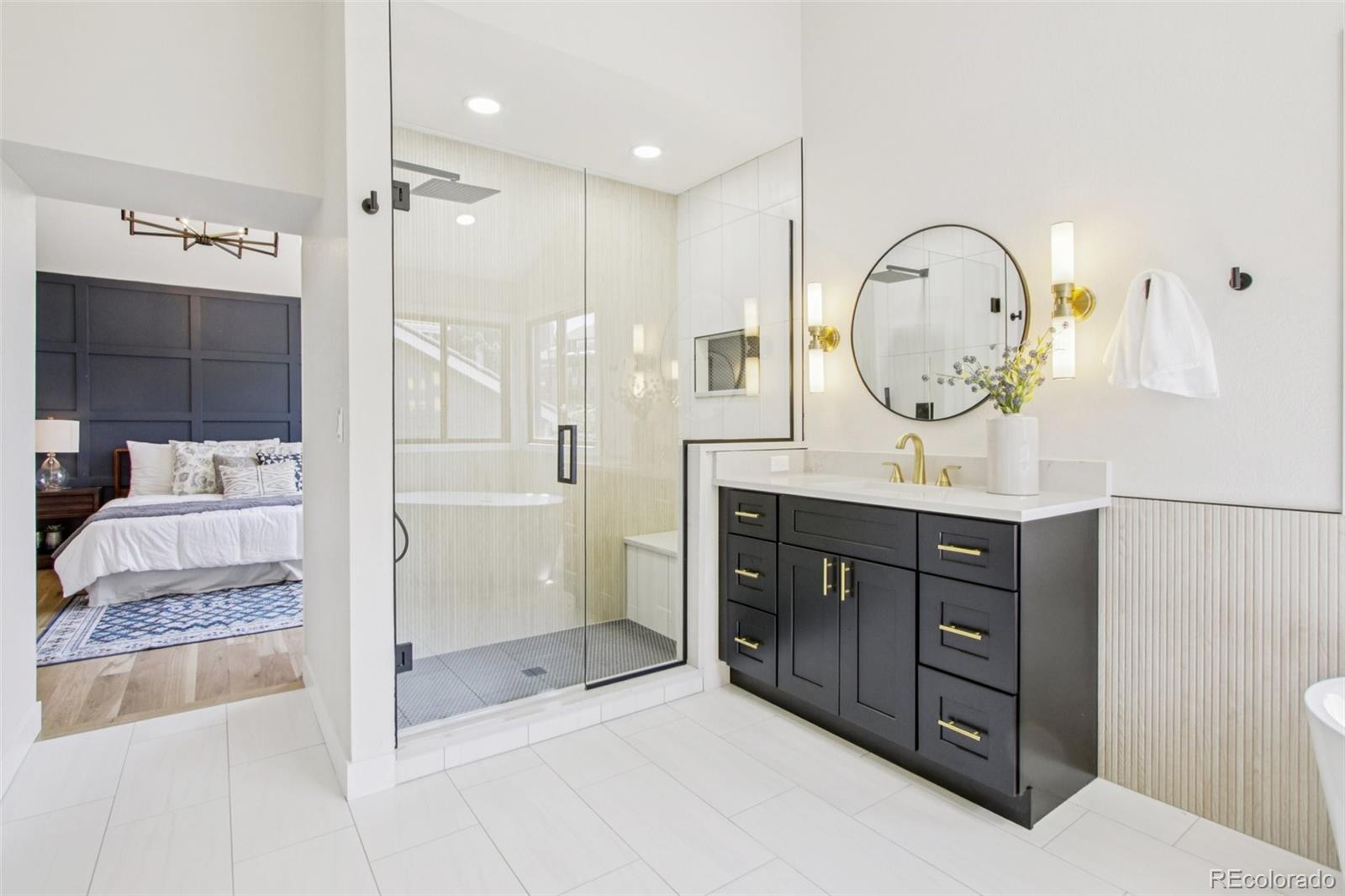 9810 Venneford Ranch Road Highlands Ranch, CO 80126 - Photo 25 of 50 a bathroom with a mirror a sink and a shower
