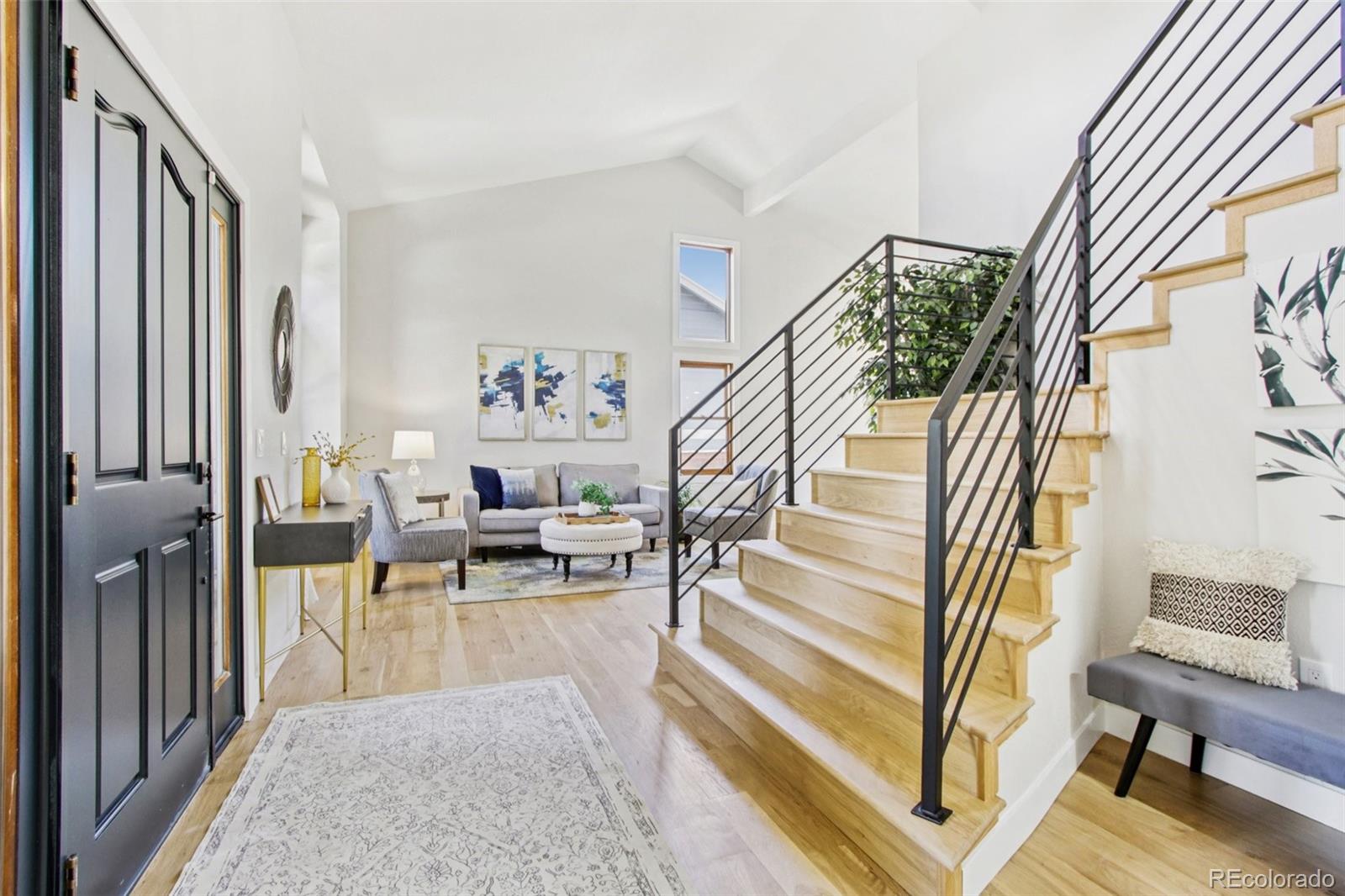 9810 Venneford Ranch Road Highlands Ranch, CO 80126 - Photo 3 of 50 a living room with furniture and a fireplace
