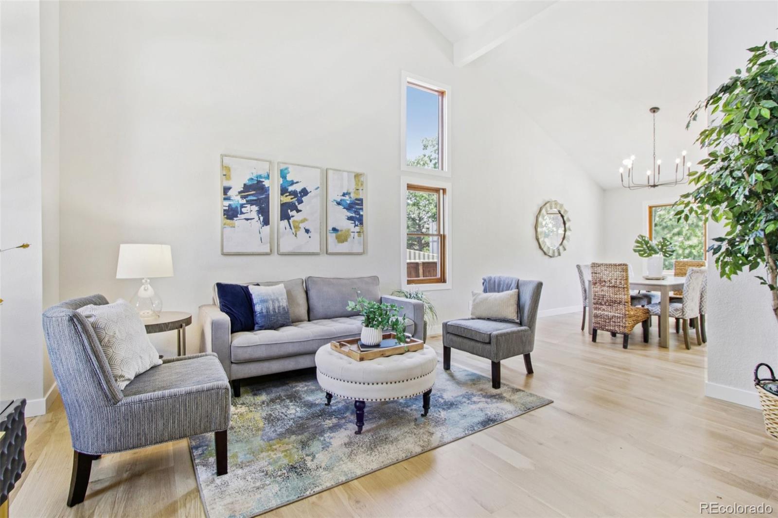 9810 Venneford Ranch Road Highlands Ranch, CO 80126 - Photo 4 of 50 a living room with furniture a rug and a potted plant