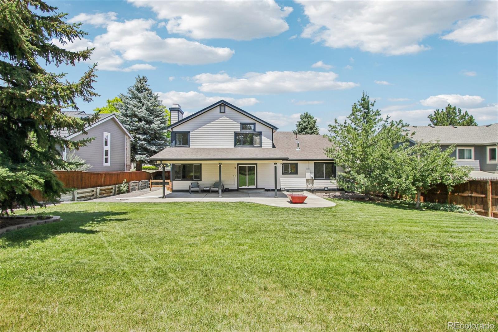 9810 Venneford Ranch Road Highlands Ranch, CO 80126 - Photo 41 of 50 a front view of a house with garden