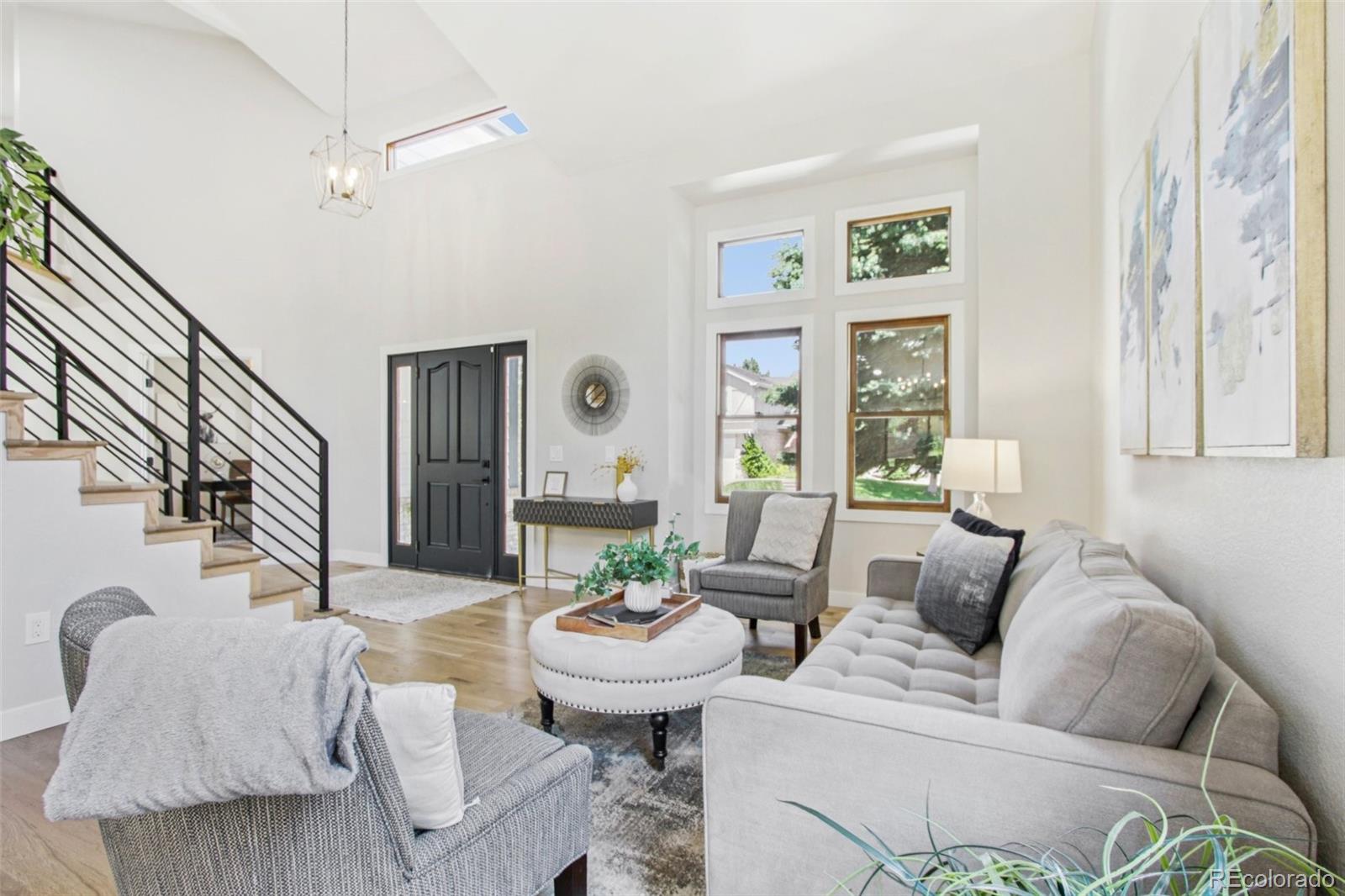 9810 Venneford Ranch Road Highlands Ranch, CO 80126 - Photo 5 of 50 a living room with furniture and a large window