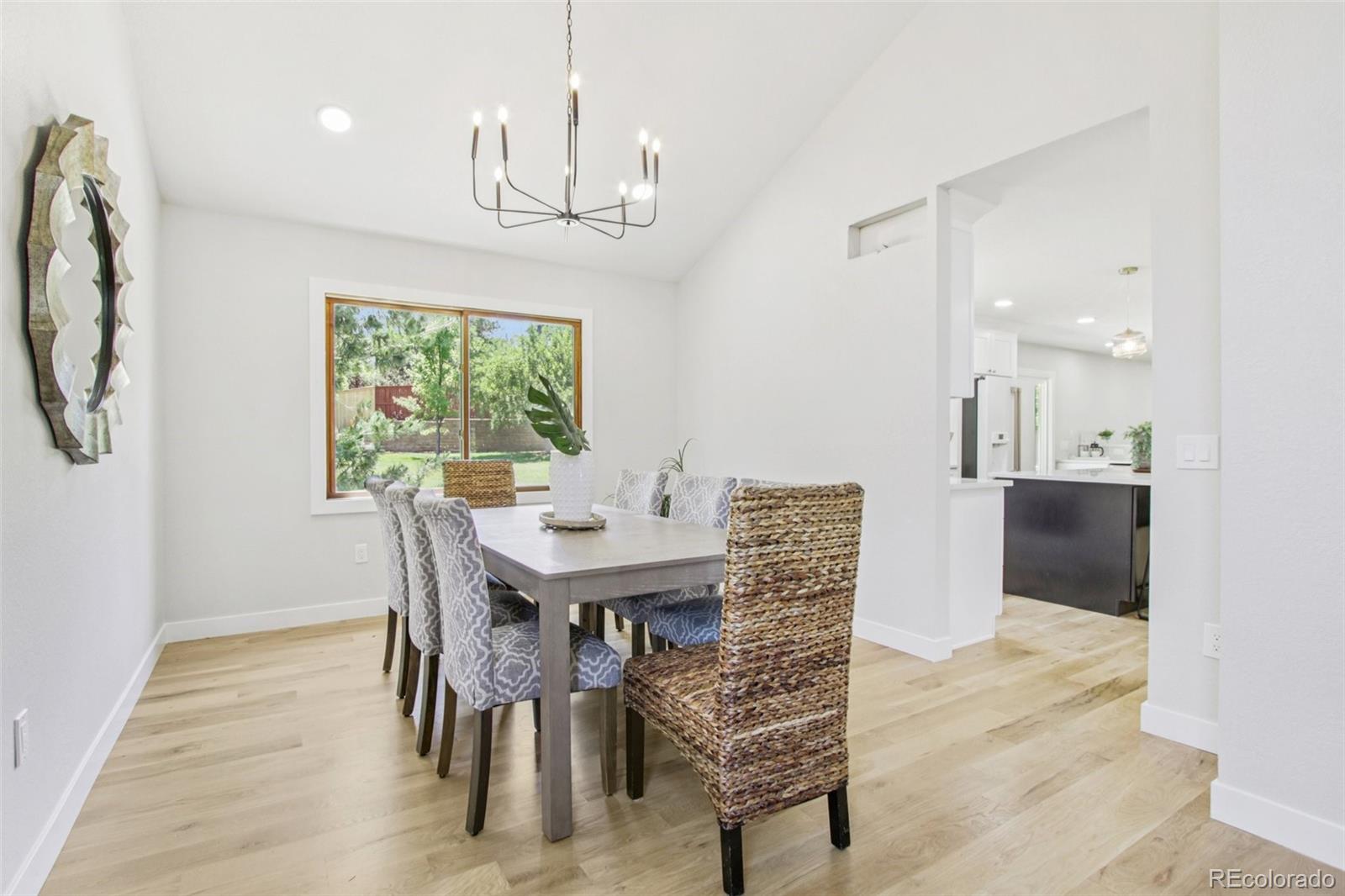 9810 Venneford Ranch Road Highlands Ranch, CO 80126 - Photo 8 of 50 a view of a dining room with furniture window and wooden floor