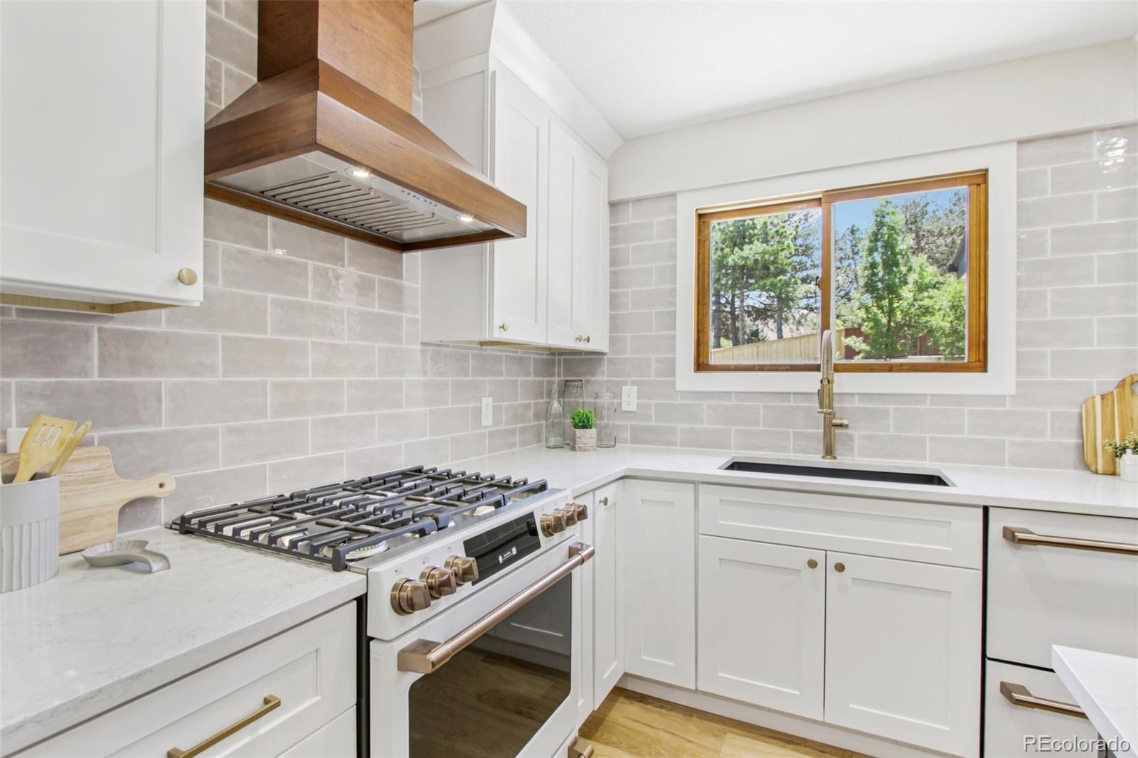 9810 Venneford Ranch Road Highlands Ranch, CO 80126 - Photo 9 of 50 a kitchen with granite countertop a sink stove and cabinets