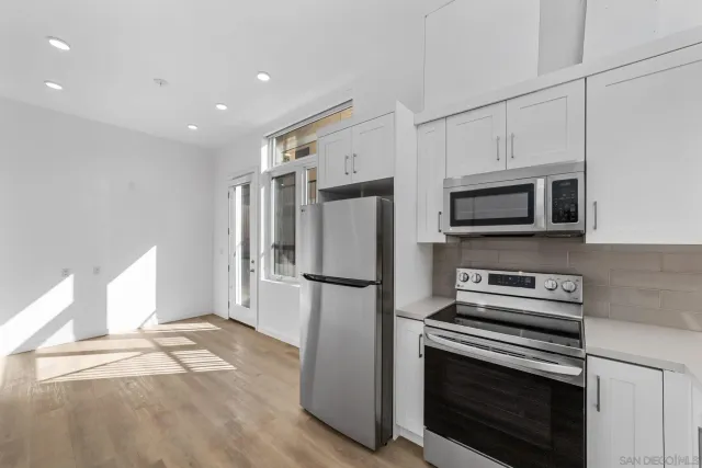 a kitchen with stainless steel appliances a refrigerator microwave and stove