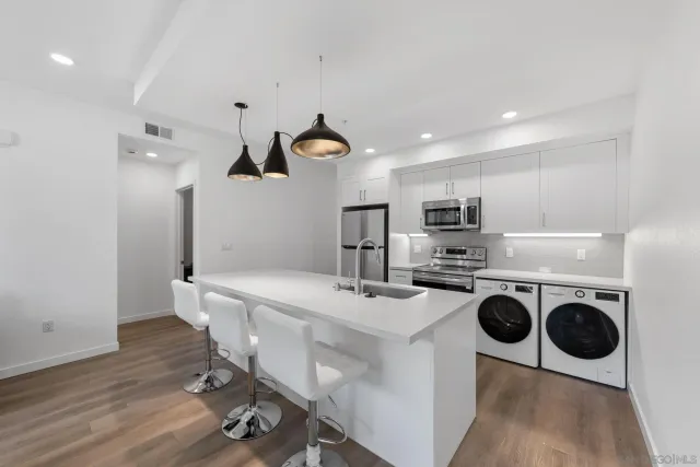 a kitchen with a sink a stove and a microwave