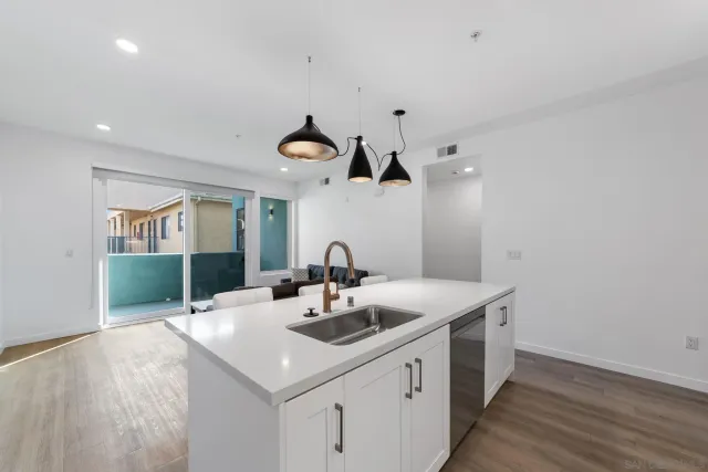 a kitchen with a sink cabinets and wooden floor