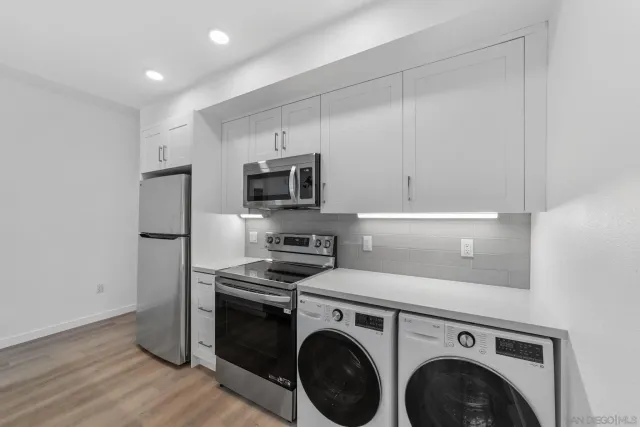 a view of kitchen with stainless steel appliances cabinets and a counter top space