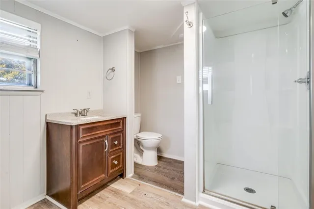 a spacious bathroom with a granite countertop sink a toilet and shower
