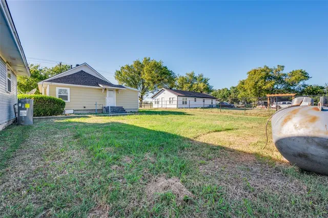 a view of a house with a swimming pool and a yard