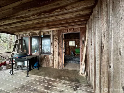 a room with a bed a mirror and a window