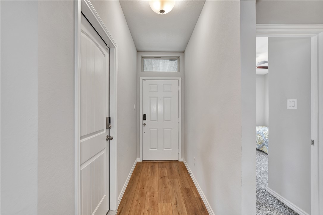 909 Davy Street Brenham, TX 77833 - Photo 5 of 35 Entryway featuring baseboards and wood finished floors