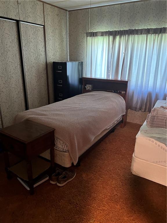 42686 Gilson Ridge Road Titusville, PA 16354 - Photo 14 of 19 a bedroom with a bed and wooden floor