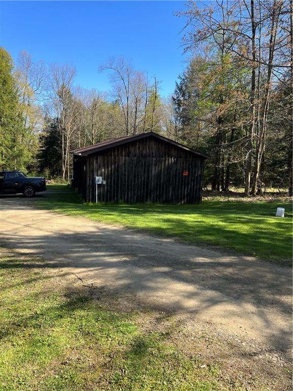 42686 Gilson Ridge Road Titusville, PA 16354 - Photo 3 of 19 a view of a swimming pool with an outdoor space and seating area