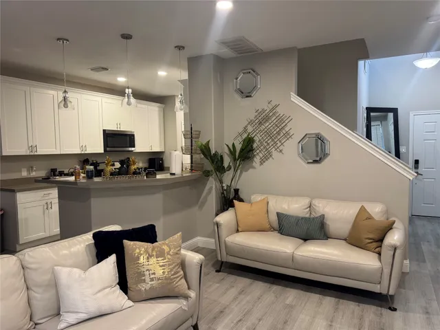 a living room with furniture kitchen view and a fireplace