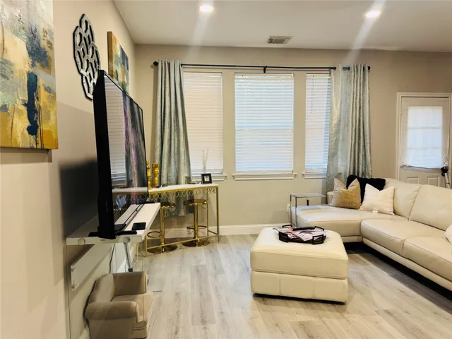 a living room with furniture and a large window