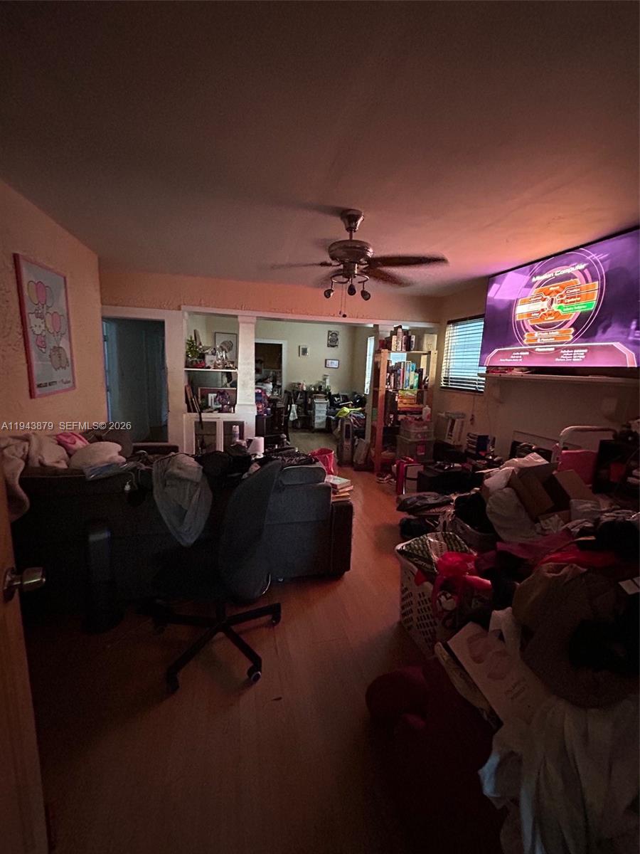 6500 Southwest 60th Avenue South Miami, FL 33143 - Photo 7 of 9 a living room with lots of furniture and a flat screen tv