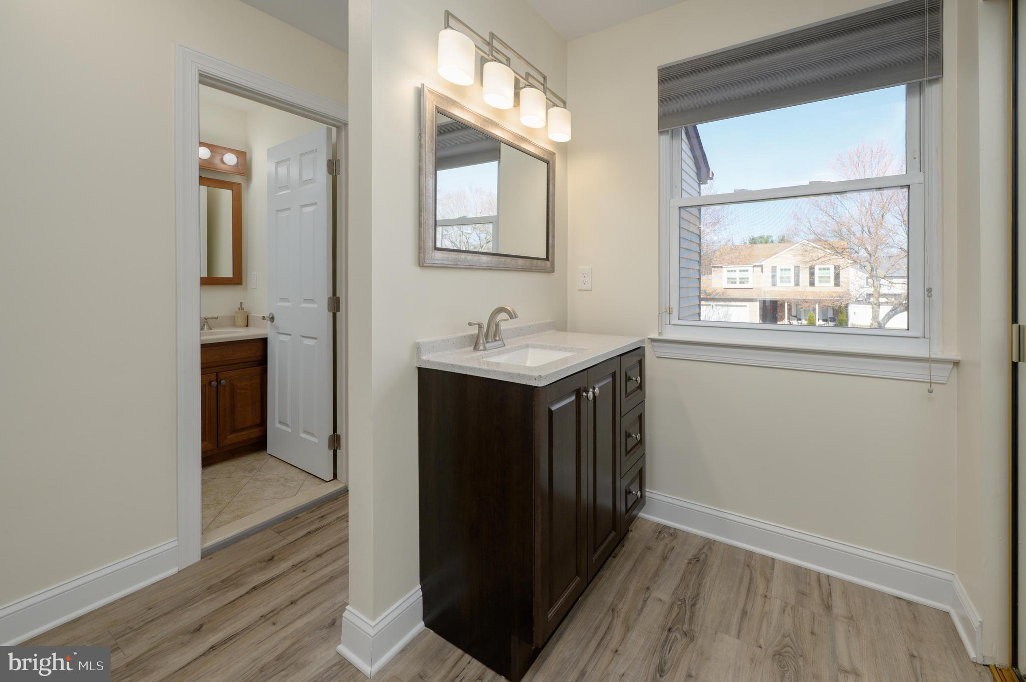 82 Boothby Drive Mount Laurel, NJ 08054 - Photo 13 of 20 a hallway with a sink and a mirror