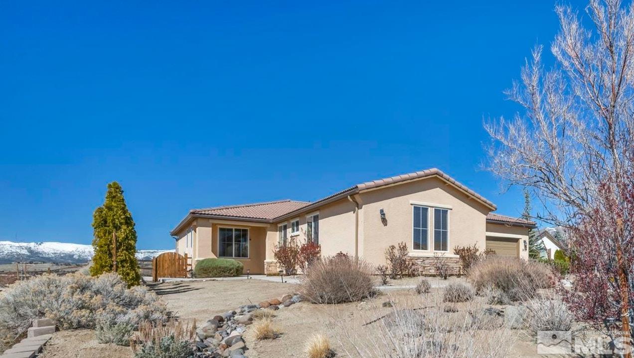 a view of a house with wooden fence