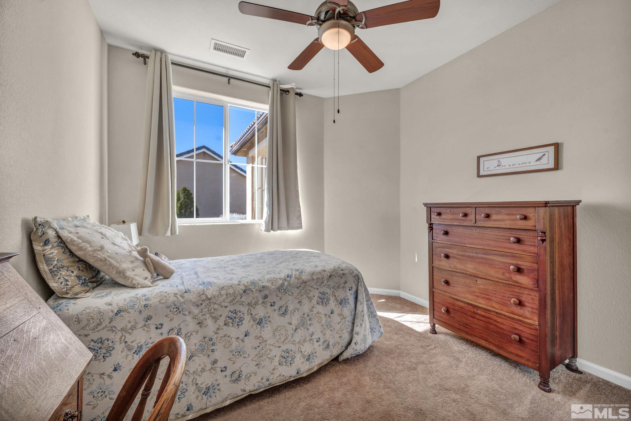 1479 Snow Summit Drive Reno, NV 89523 - Photo 19 of 40 a bedroom with a bed and a dresser