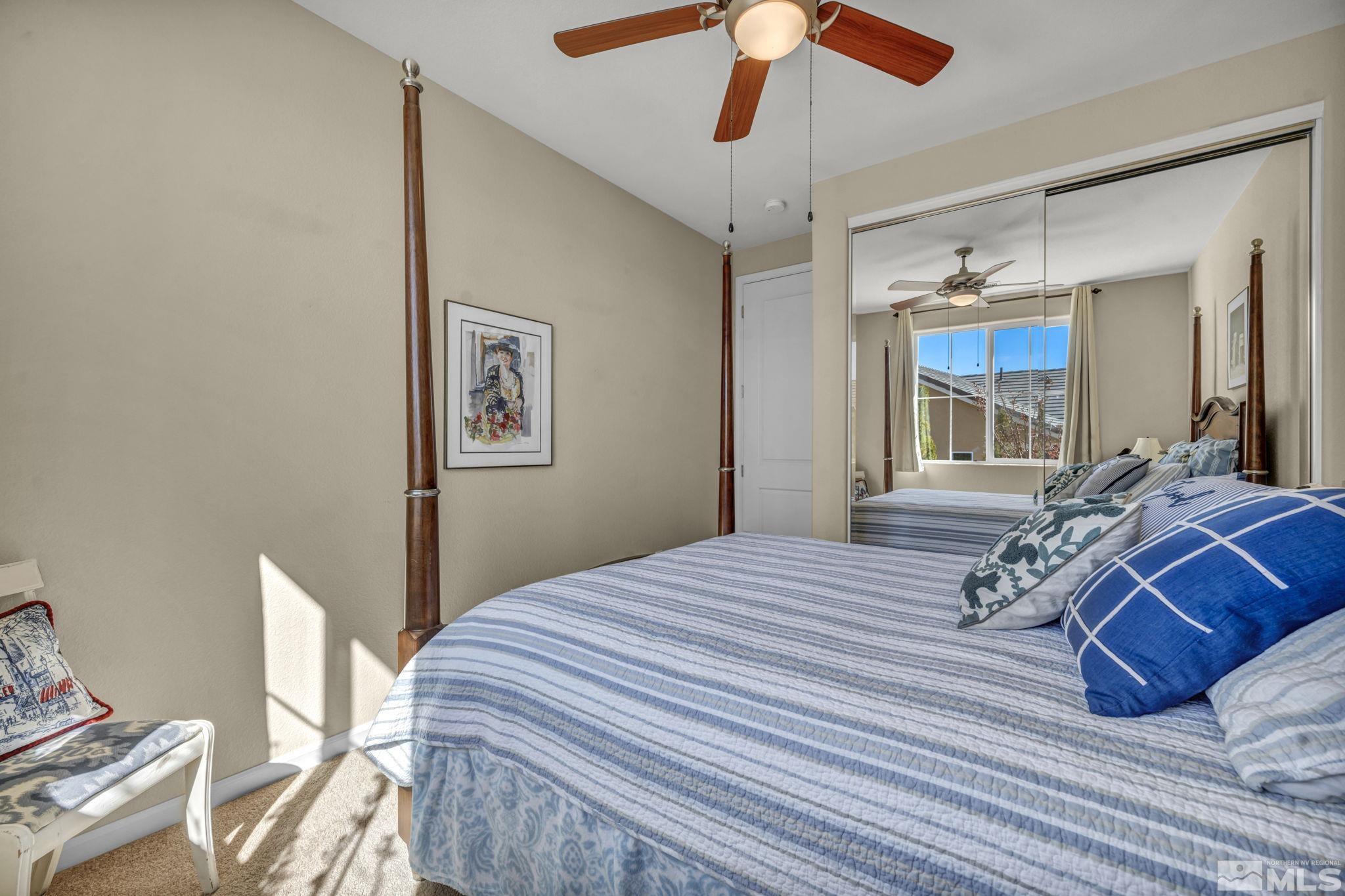 1479 Snow Summit Drive Reno, NV 89523 - Photo 23 of 40 a bedroom with a bed and a chandelier