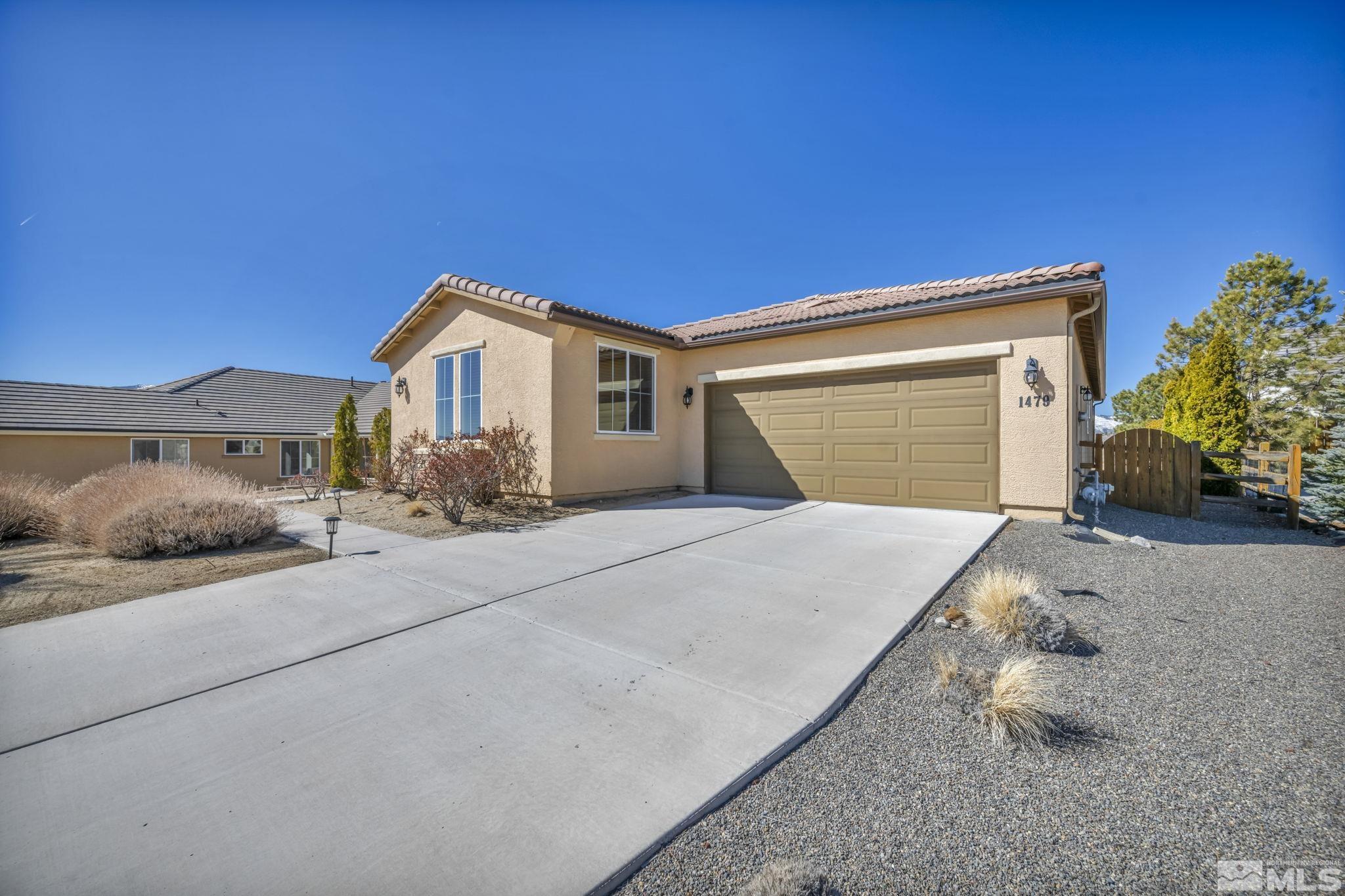 1479 Snow Summit Drive Reno, NV 89523 - Photo 37 of 40 a front view of a house with a yard and garage