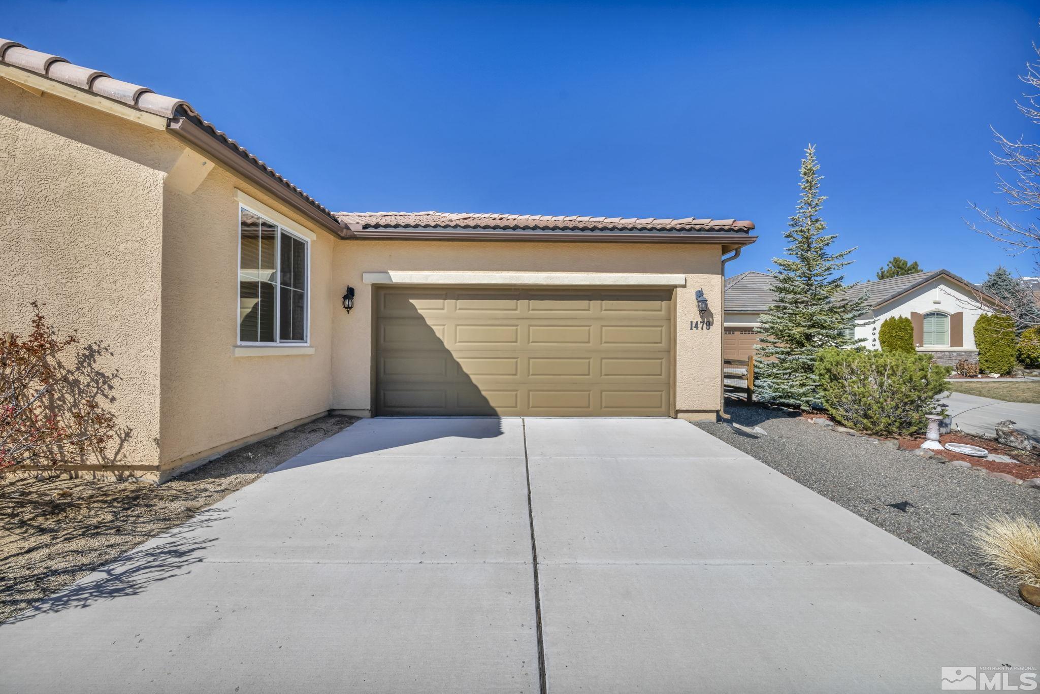 1479 Snow Summit Drive Reno, NV 89523 - Photo 38 of 40 a front view of a house with a yard and garage
