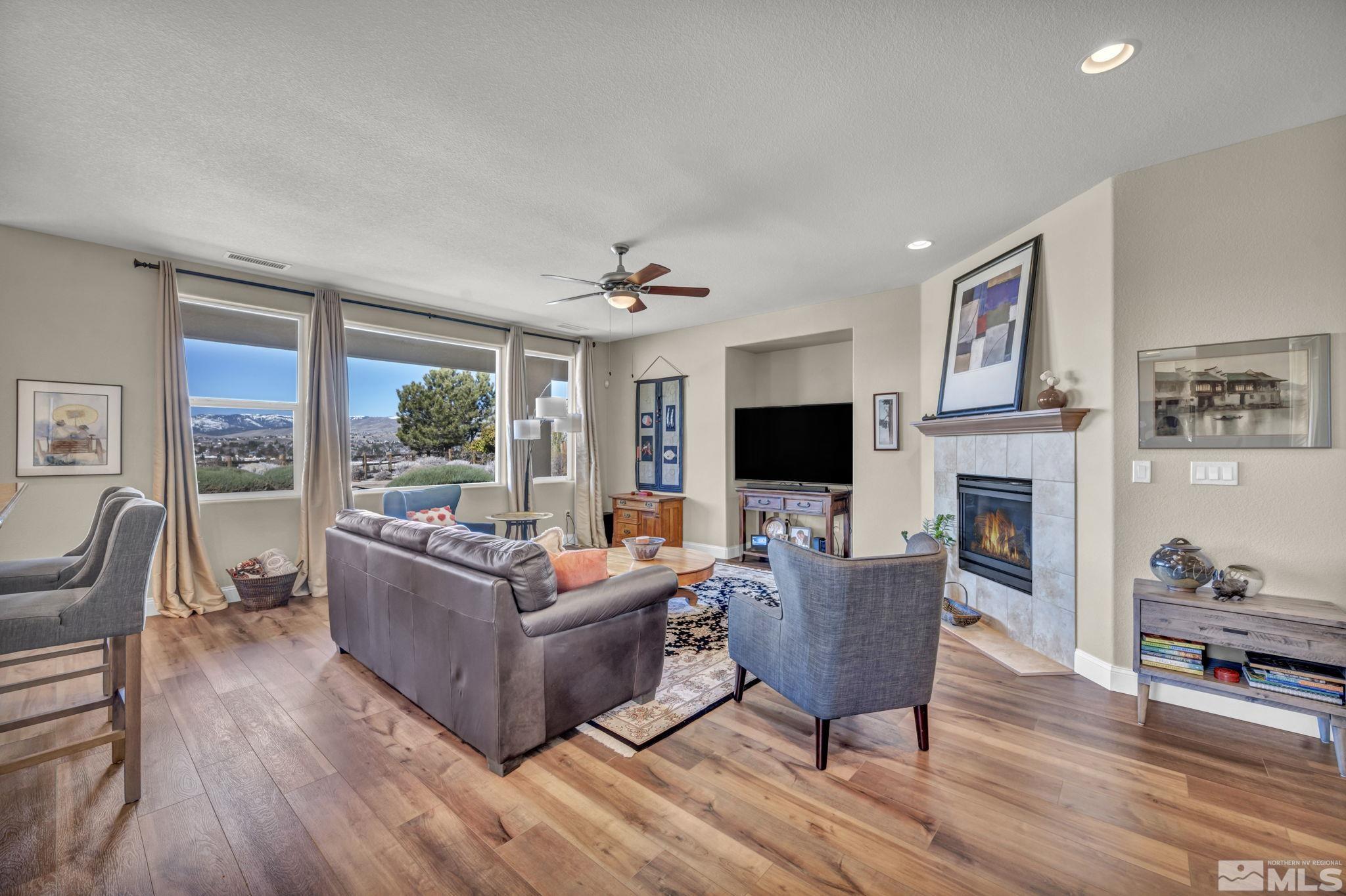 1479 Snow Summit Drive Reno, NV 89523 - Photo 4 of 40 a living room with furniture flat screen tv and a fireplace