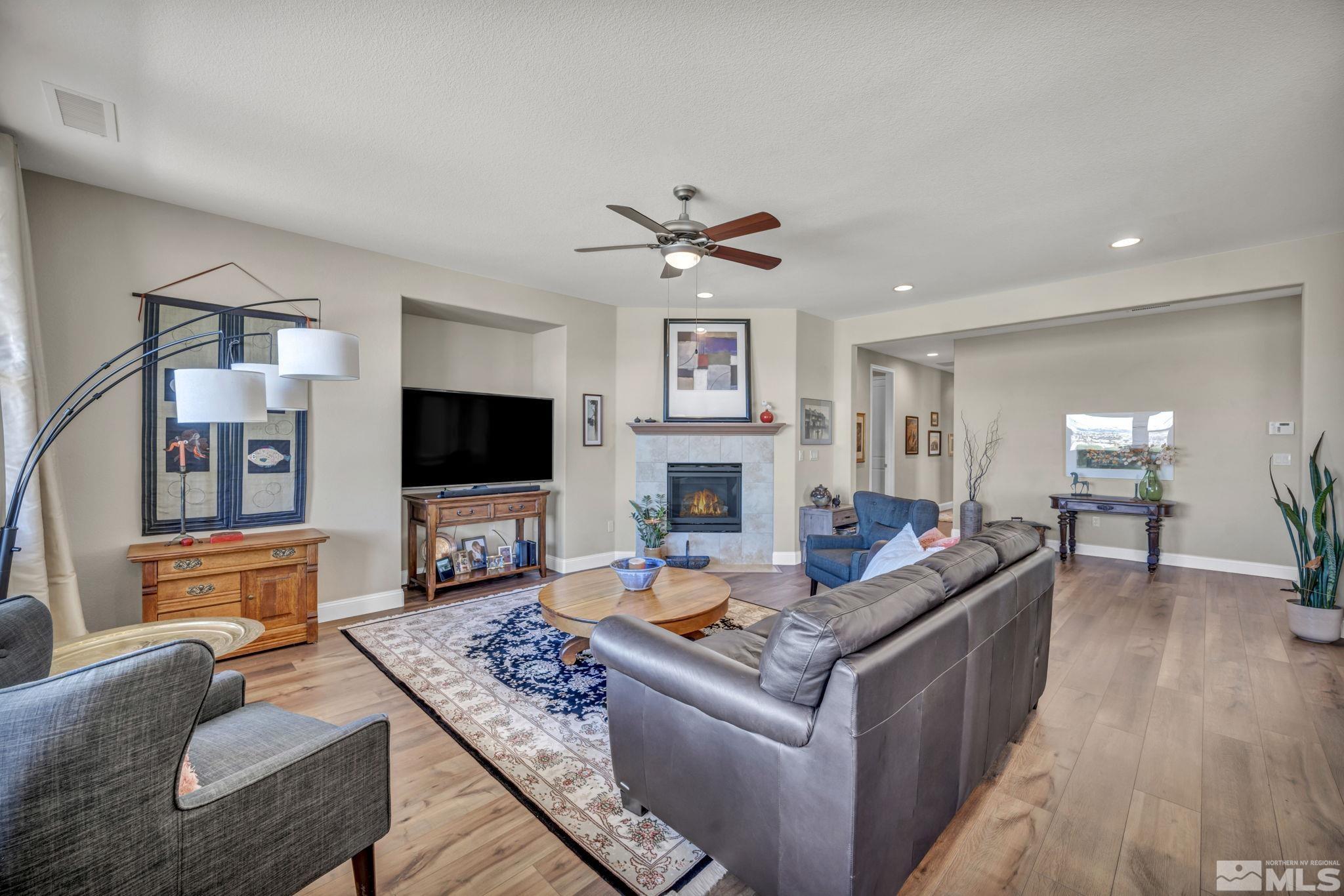 1479 Snow Summit Drive Reno, NV 89523 - Photo 8 of 40 a living room with fireplace furniture and a flat screen tv