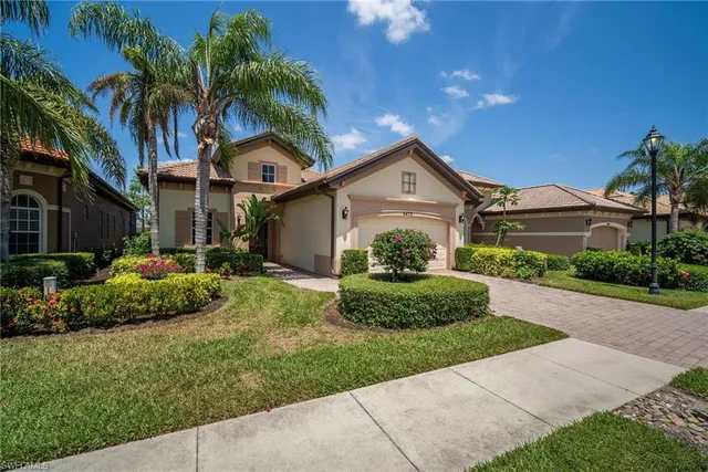 a front view of a house with a garden and plants