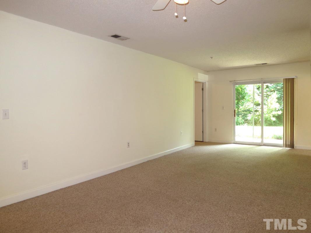 303 Smith Level Road, Unit F11 Chapel Hill, NC 27516 - Photo 3 of 14 an empty room with windows