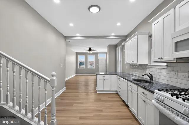 a kitchen with granite countertop a sink and cabinets