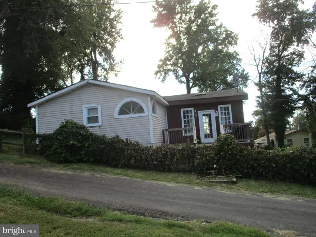 a white house that has a tree in front of it